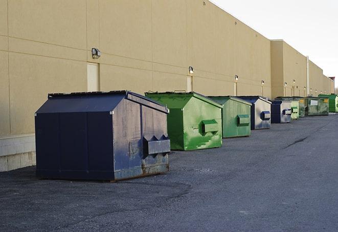 construction workers loading debris into dumpsters in Baltimore, OH